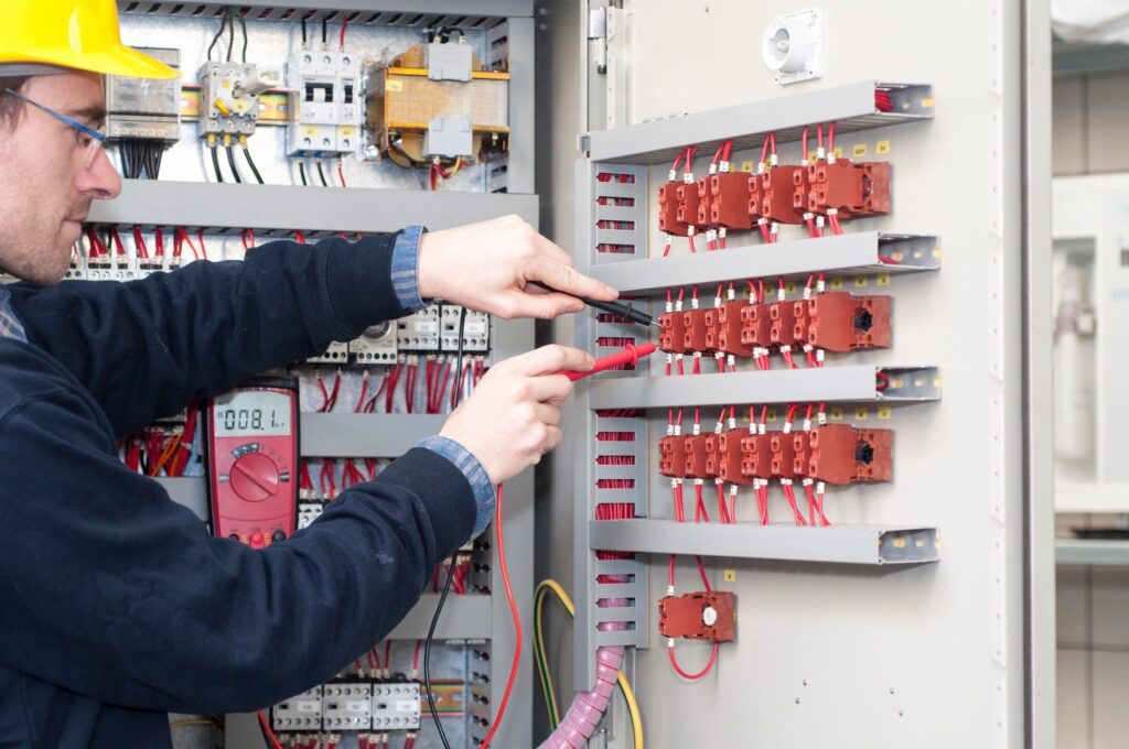 An Electrician working on electrical equipment