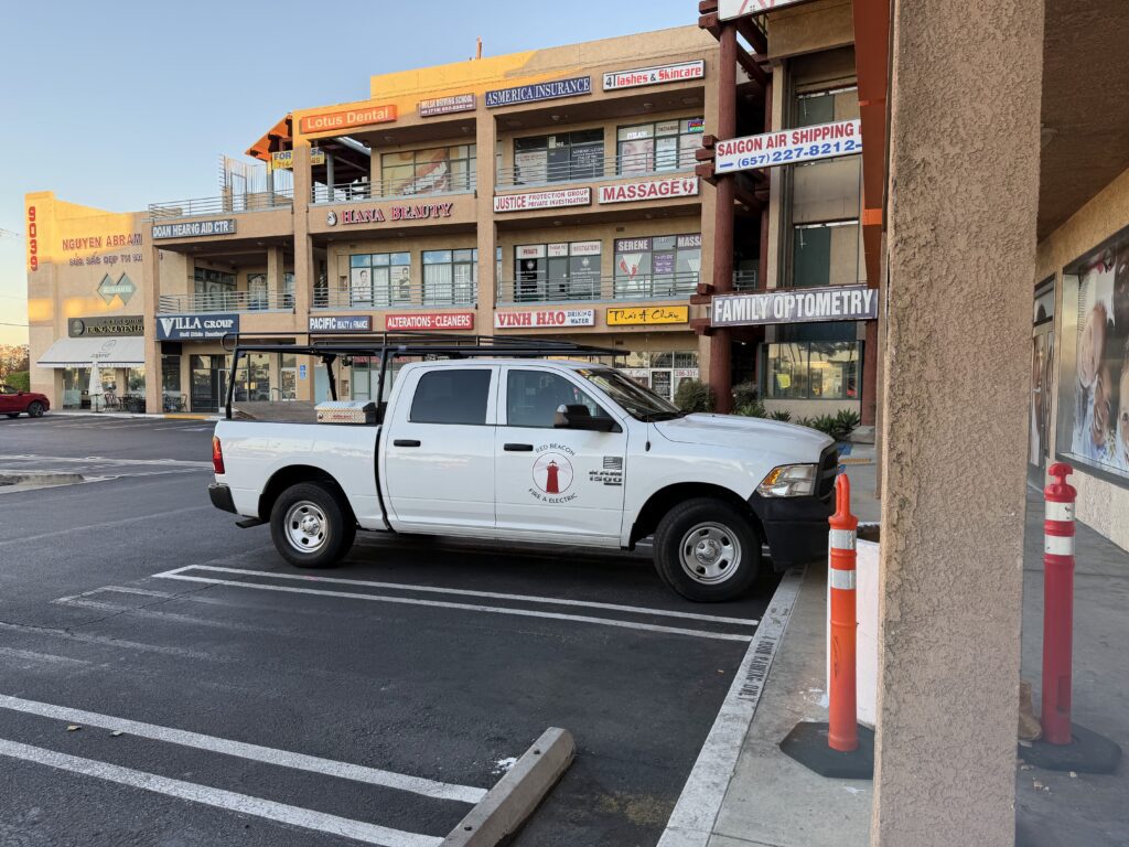 A Red Beacon truck in front of a restaurant undergoing a commercial electrical remodel.