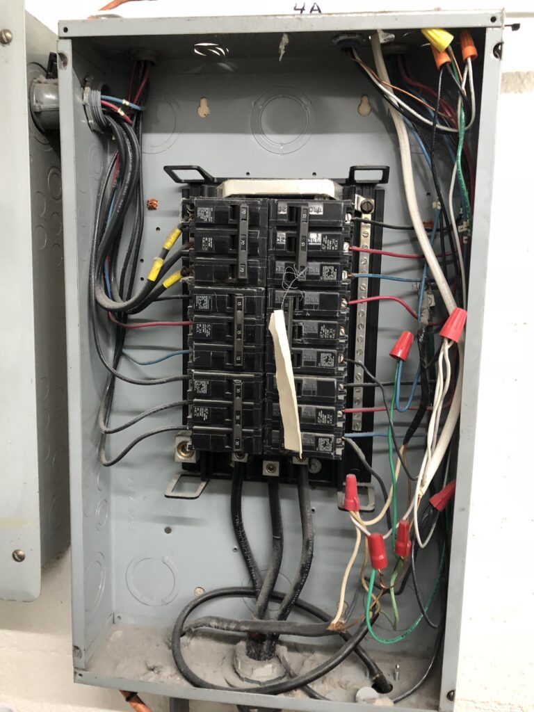 A fusebox being worked on in a commercial restaurant.