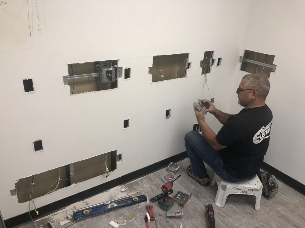 A man working on a commercial electrical remodel in a restaurant.